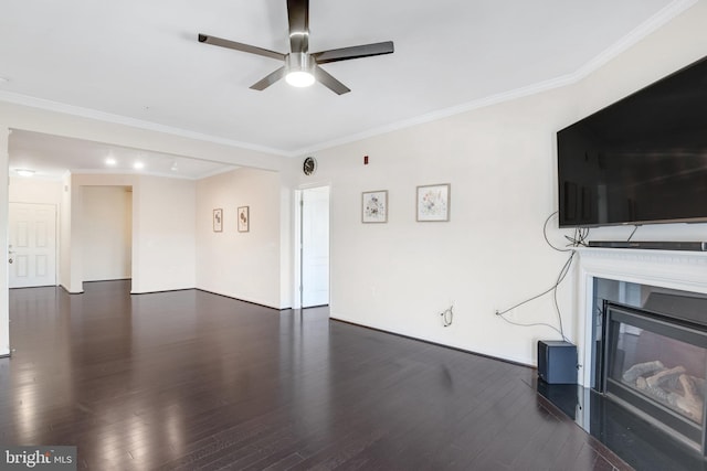 unfurnished living room featuring ornamental molding, dark wood-type flooring, and ceiling fan