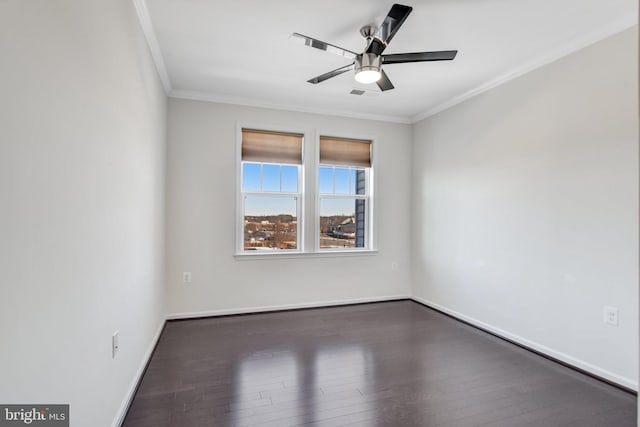 spare room featuring ornamental molding, dark hardwood / wood-style flooring, and ceiling fan