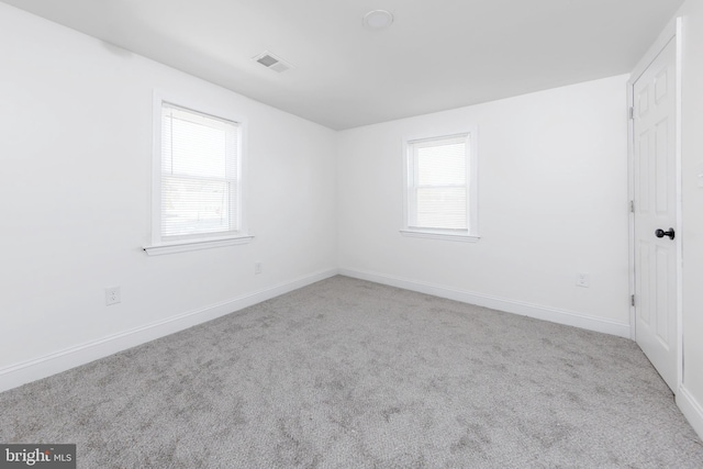 empty room with light colored carpet