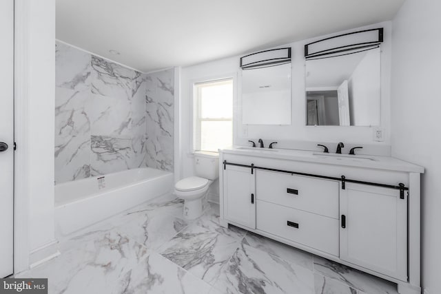 full bathroom with toilet, vanity, and tiled shower / bath