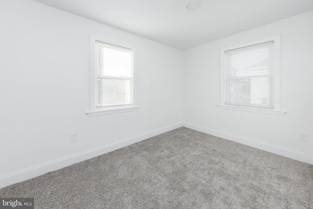 unfurnished room featuring carpet