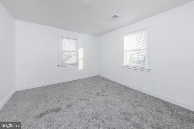 carpeted spare room with plenty of natural light