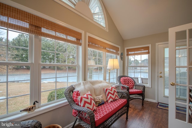 sunroom / solarium featuring lofted ceiling and plenty of natural light