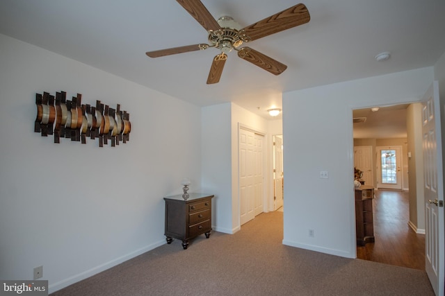 spare room with carpet floors and ceiling fan