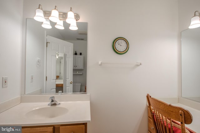 bathroom with toilet and vanity