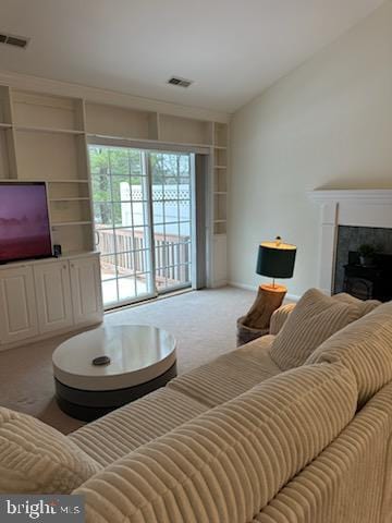 carpeted living room with built in shelves