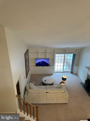 carpeted living room with a fireplace