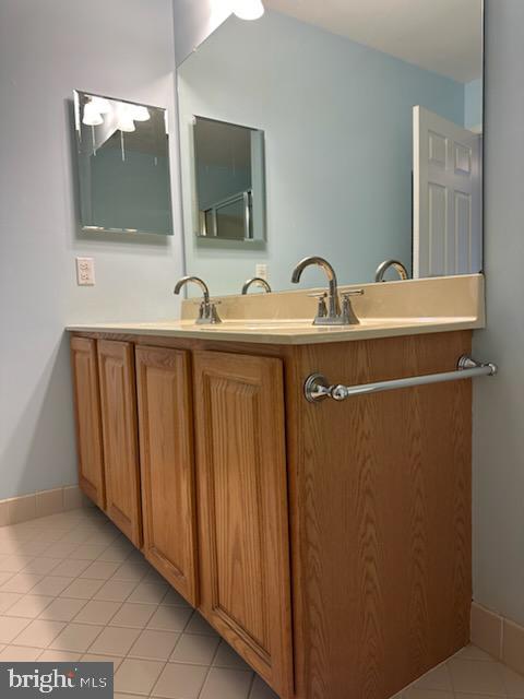 bathroom with tile patterned floors and vanity