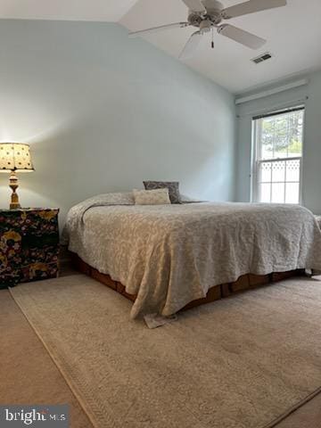 bedroom with vaulted ceiling, ceiling fan, and carpet