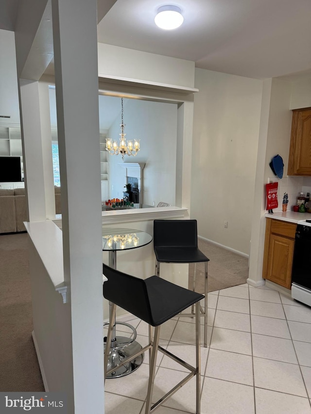 dining area featuring light colored carpet and a chandelier