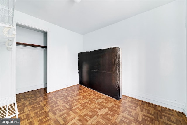 unfurnished bedroom with parquet floors