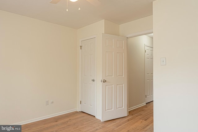 unfurnished bedroom with ceiling fan and light hardwood / wood-style floors