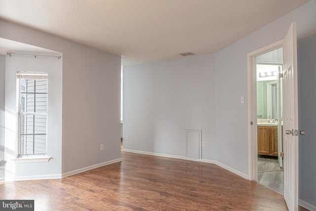 unfurnished room with wood-type flooring