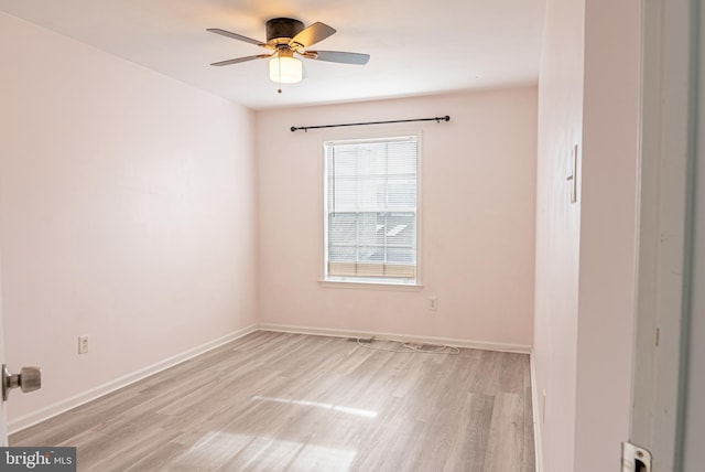 spare room with ceiling fan and light wood-type flooring