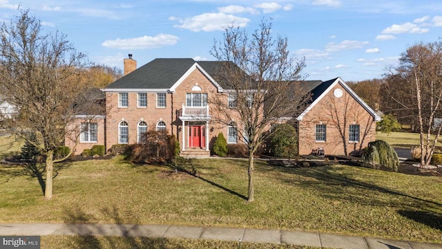 colonial home with a front yard