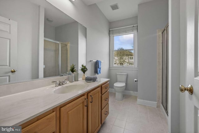 bathroom with toilet, vanity, tile patterned flooring, and a shower with door