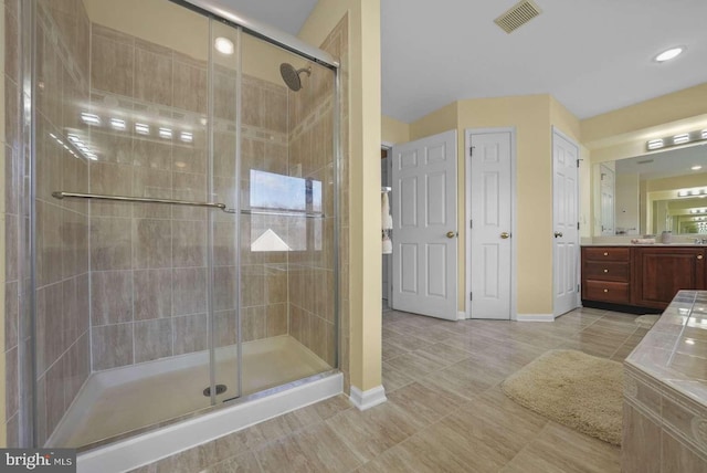 bathroom with vanity, tile patterned floors, and walk in shower