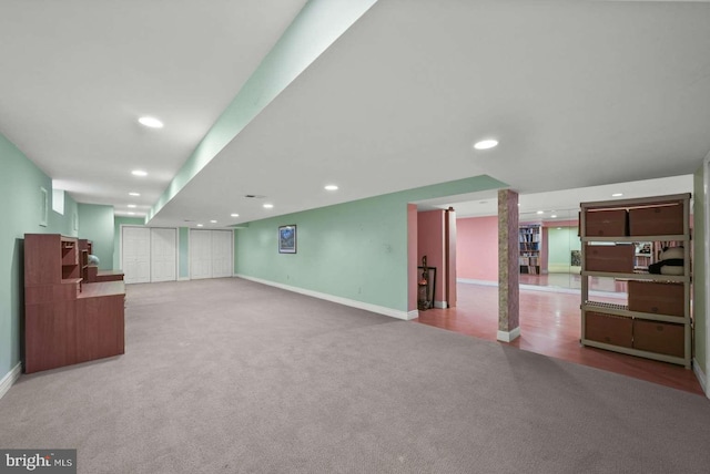 basement featuring light colored carpet