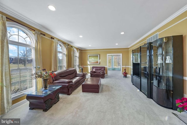 carpeted living room featuring ornamental molding