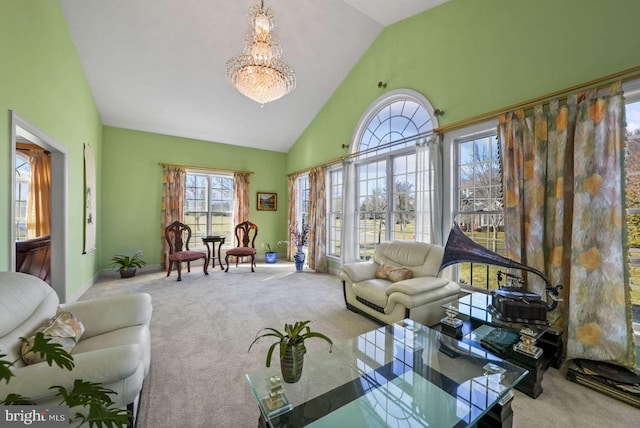 living room with carpet floors, a notable chandelier, and high vaulted ceiling