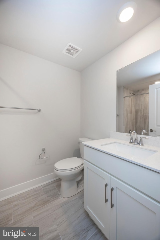 bathroom featuring vanity, toilet, and a shower with shower curtain