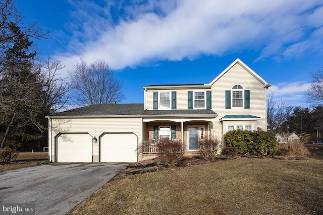 front facade featuring a garage and a front lawn