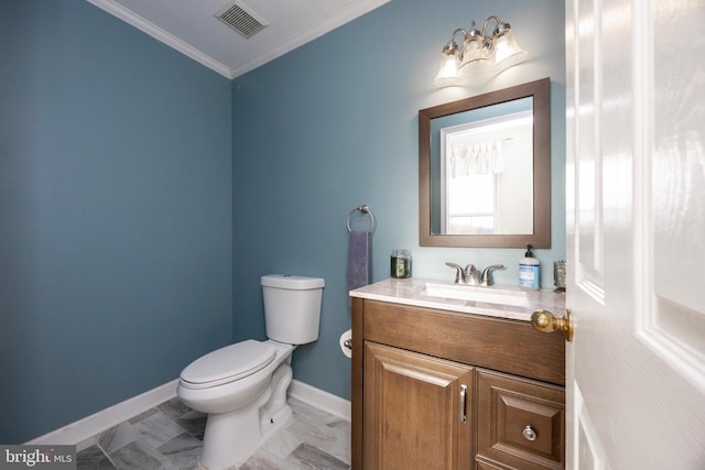 bathroom with vanity, crown molding, and toilet