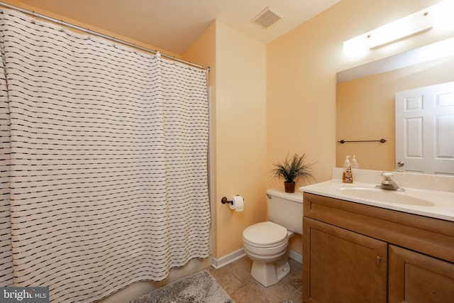 bathroom featuring vanity, tile patterned flooring, and toilet