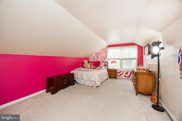 bedroom featuring light carpet and vaulted ceiling