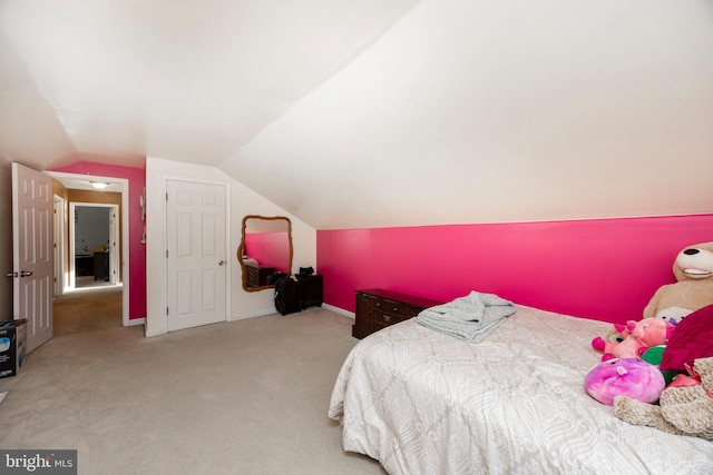 bedroom featuring lofted ceiling and light colored carpet