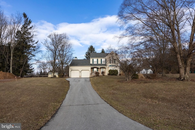 view of front of house featuring a garage and a front lawn