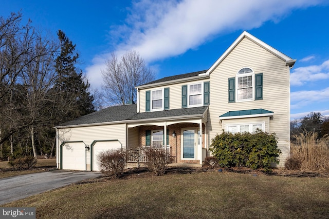 front facade featuring a garage, covered porch, and a front lawn