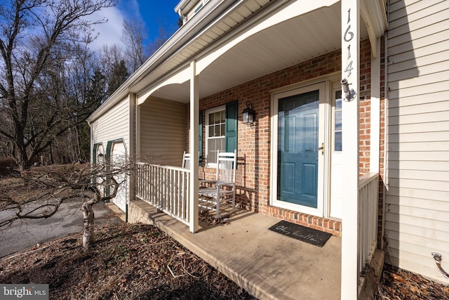 property entrance with a garage and covered porch