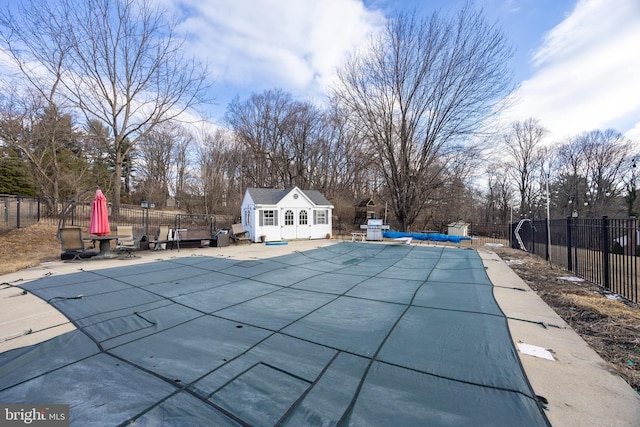 view of swimming pool featuring a patio and an outdoor structure