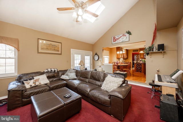 carpeted living room with high vaulted ceiling and ceiling fan