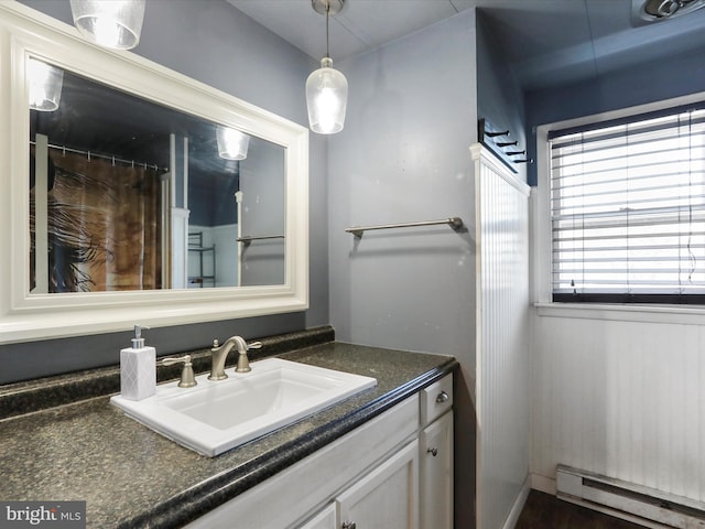 bathroom featuring vanity and baseboard heating