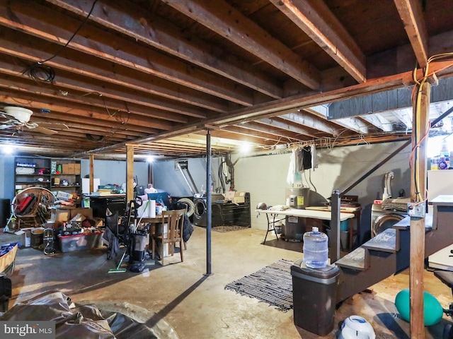 basement featuring water heater and independent washer and dryer