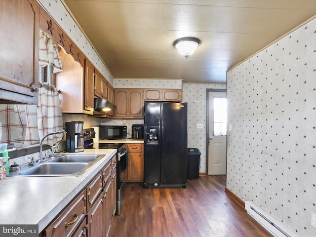 kitchen with a baseboard heating unit, dark wood-type flooring, black appliances, and sink