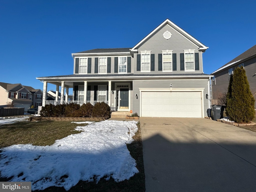 view of front of house with a porch and a garage