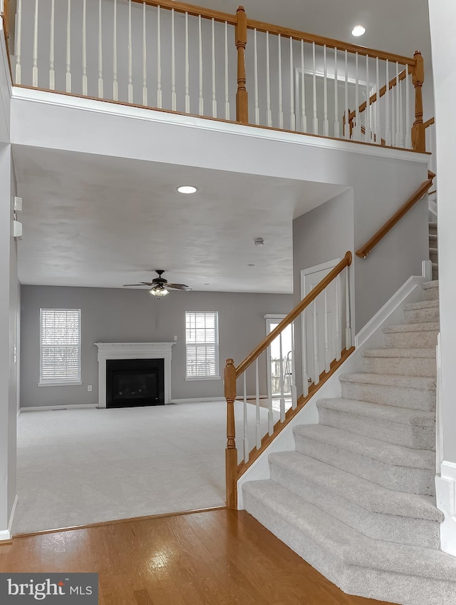 unfurnished living room featuring hardwood / wood-style floors and ceiling fan