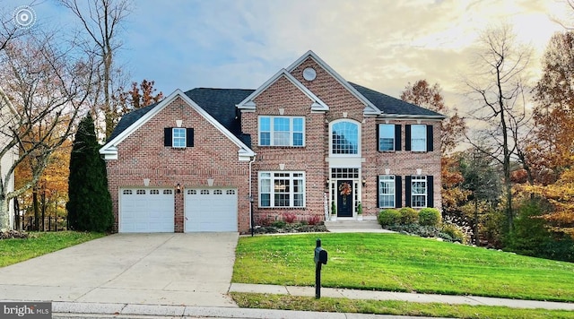 view of front of property featuring a garage and a front yard