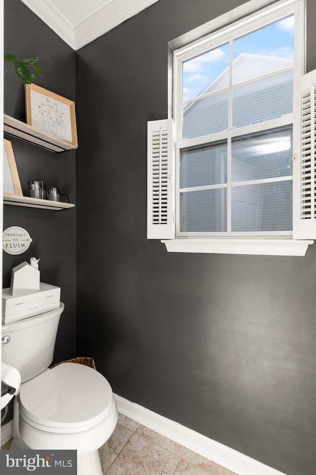 bathroom with crown molding and toilet