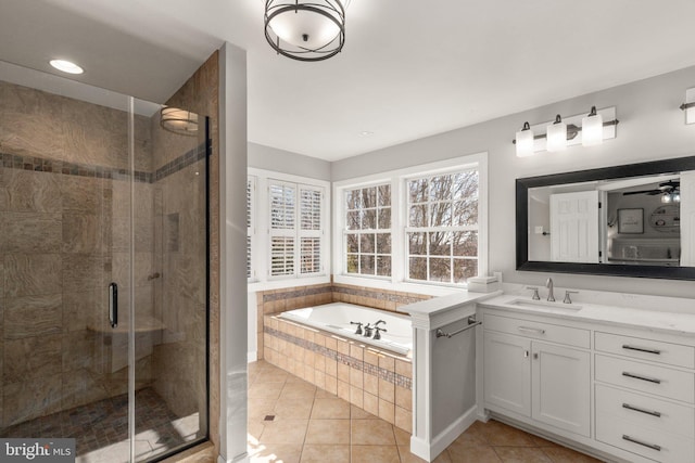 bathroom featuring tile patterned flooring, vanity, and separate shower and tub