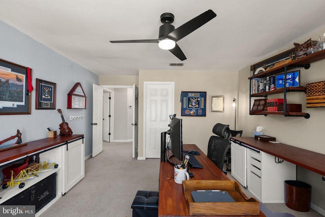 carpeted office with ceiling fan