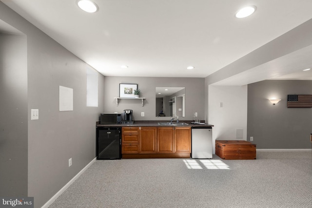 kitchen with light carpet, sink, beverage cooler, and dishwasher