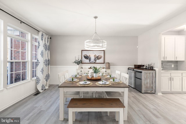 dining room featuring a notable chandelier and light wood-type flooring