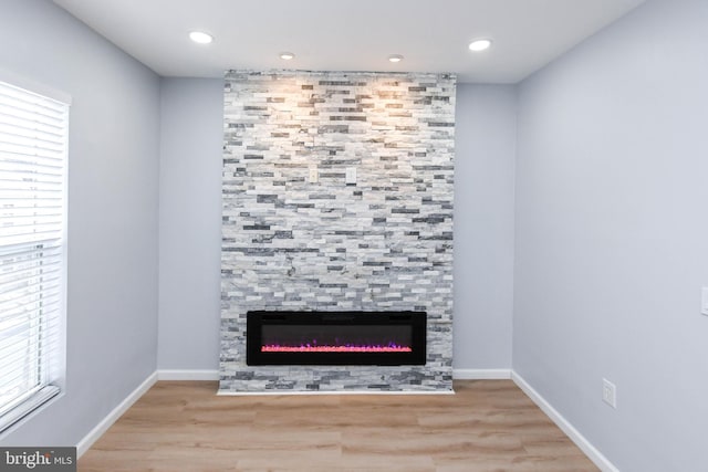 details featuring wood-type flooring and a tile fireplace