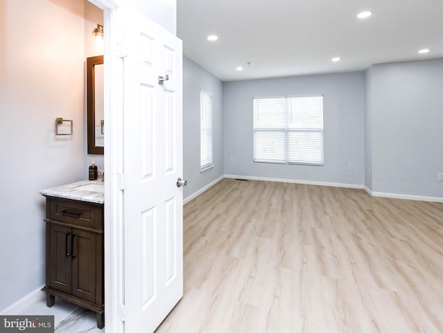 interior space featuring vanity and hardwood / wood-style floors