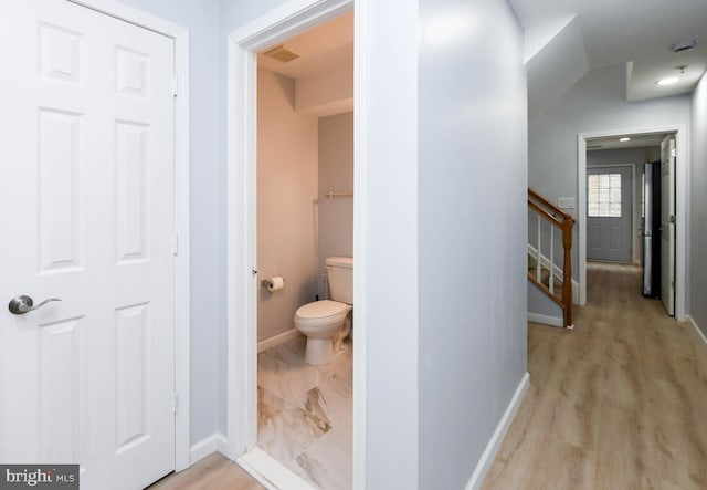 bathroom featuring baseboards, visible vents, toilet, and wood finished floors