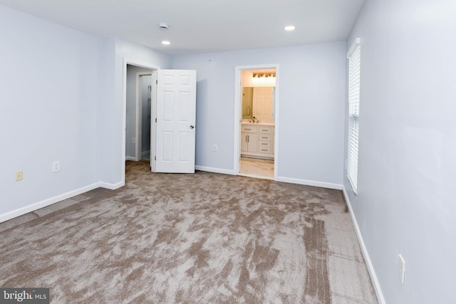 unfurnished bedroom with carpet floors and connected bathroom